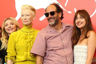 Shocking: Dakota Johnson in awkward moment with director Luca Guadagnino as he prevents dress slippage